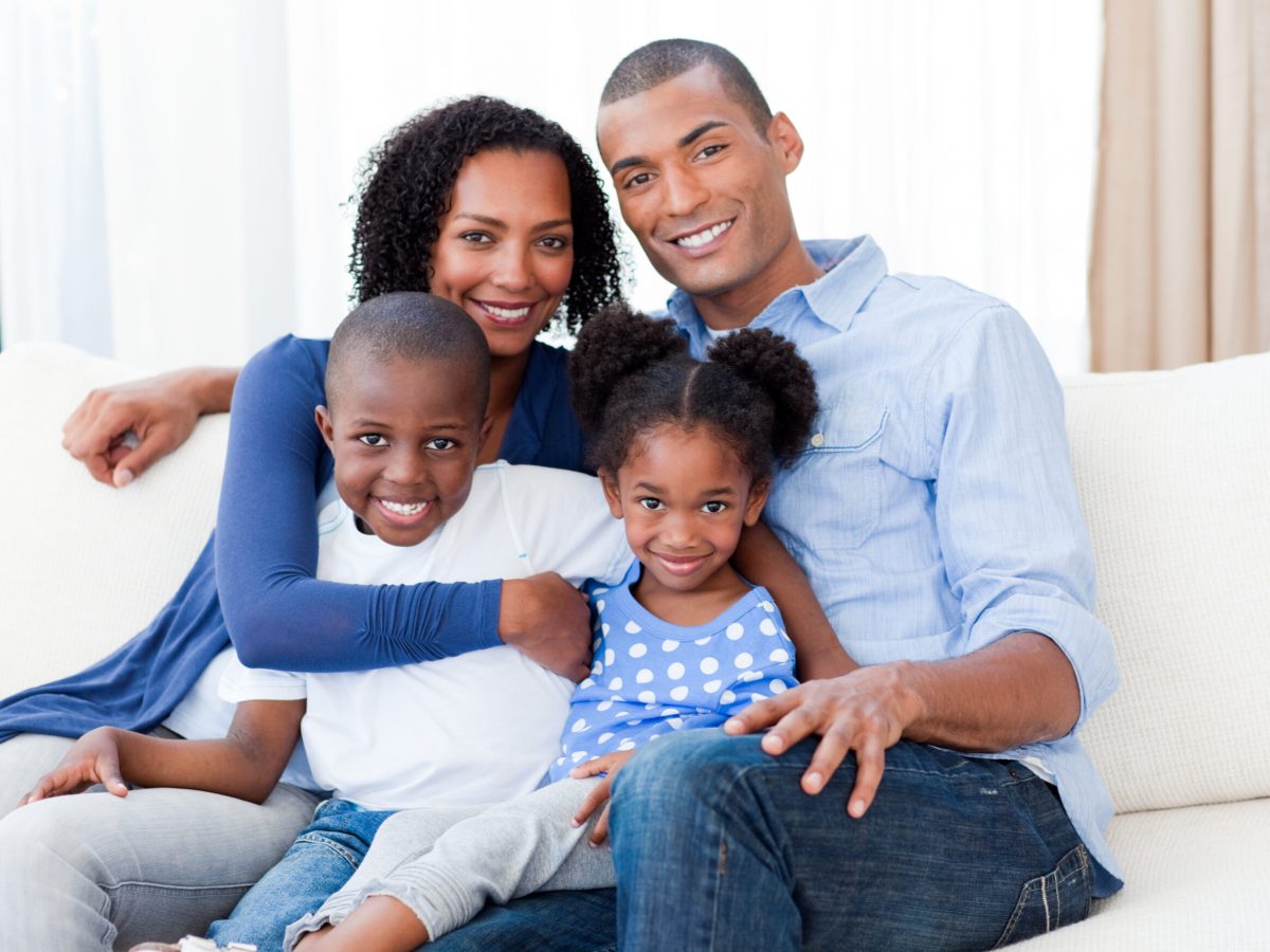 Portrait of a Smiling Afro-american family on the sofa